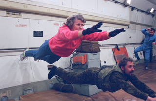 Lucid and trainer practice floating in Russian zero-g aircraft